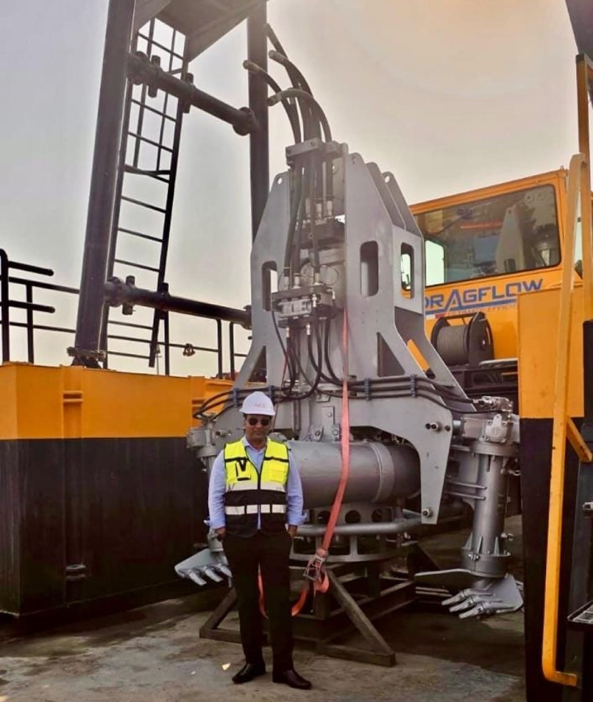 Basmni engineer standing in front of a Dragflow submersible dredge pump on a dredge deck